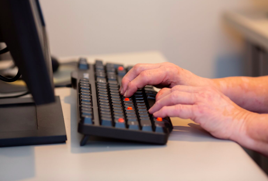 Person typing on a keyboard