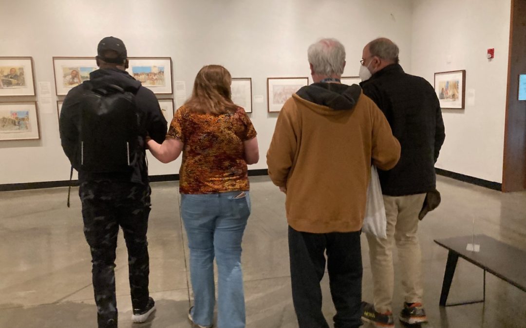 Three VLANJ participants, two using white canes, practice navigating the Montclair Art Museum, guided by a VLANJ orientation and mobility expert.