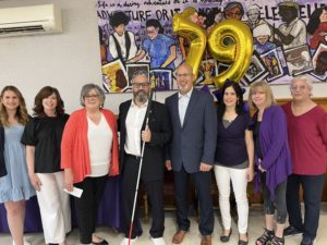 VLANJ staff members pose with Dave Steele, "The Blind Poet."